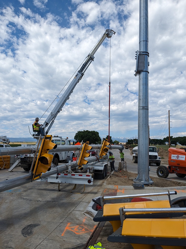 Closeup crews installing new poles and signals at the US 287 CO 52 intersection photo Tim Bricker.jpg detail image