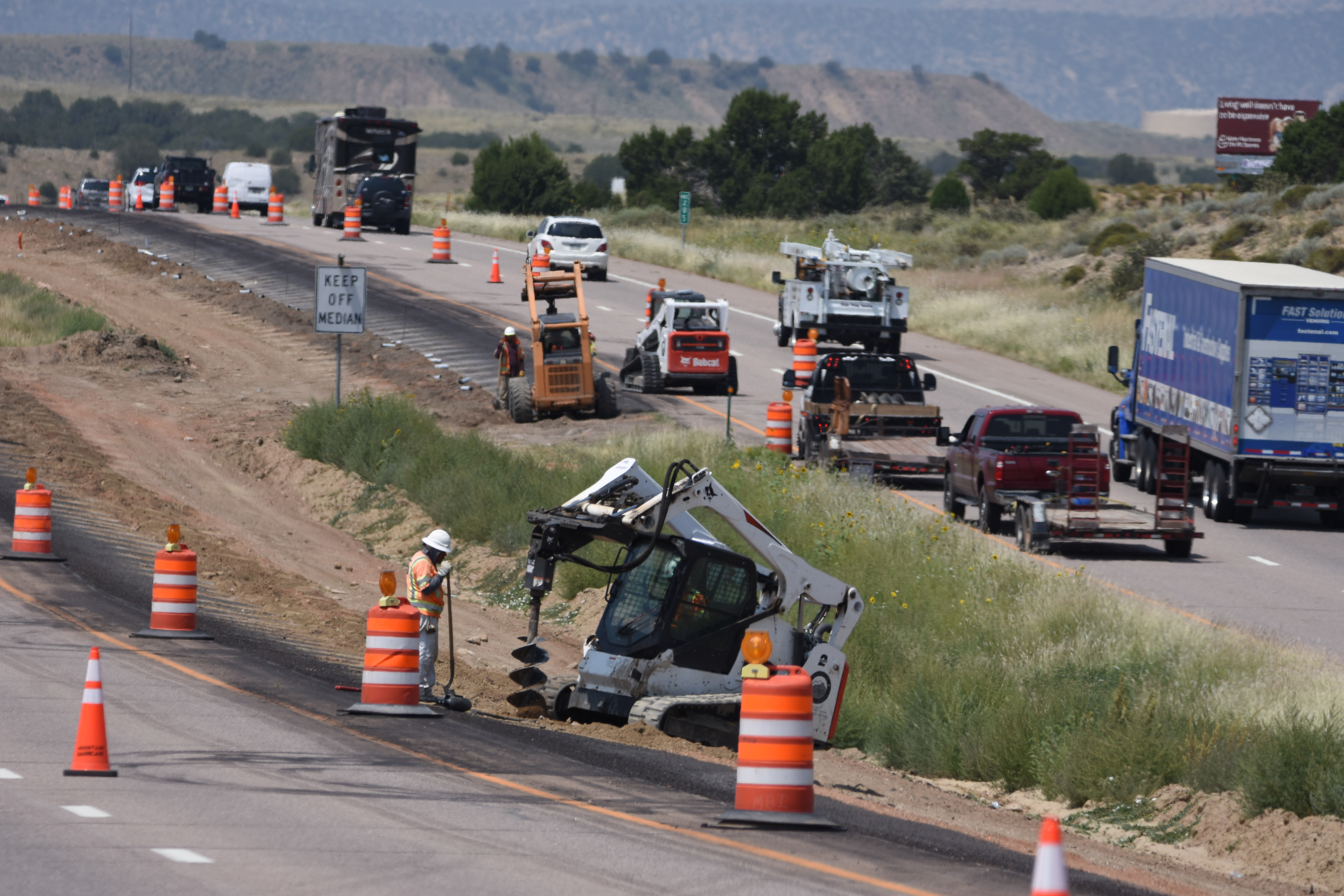 Drilling and anchoring in progress on US 50 for cable rail posts.jpg detail image