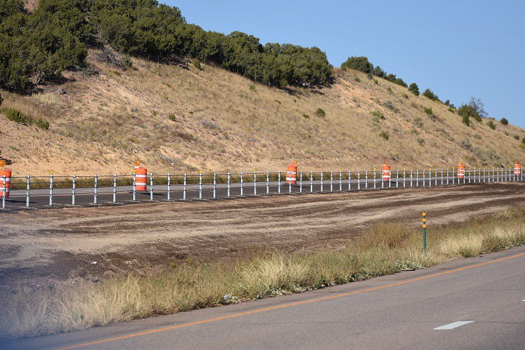 Wide view of a section of newly installed tension cable rail along US 50 just west of Penrose in Fremont County.