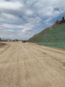 This photo was taken from the northbound side of US 85 looking north. The right side of the photo shows the northern bluff completely excavated and stabilized. (April 2021 - photo provided by Castle Rock Construction) thumbnail image