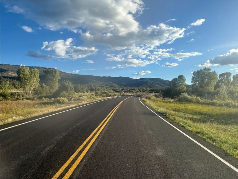The new asphalt road surface with a fresh coat of reflective paint striping on CO 151 between Ignacio and Chimney Rock National Monument.
