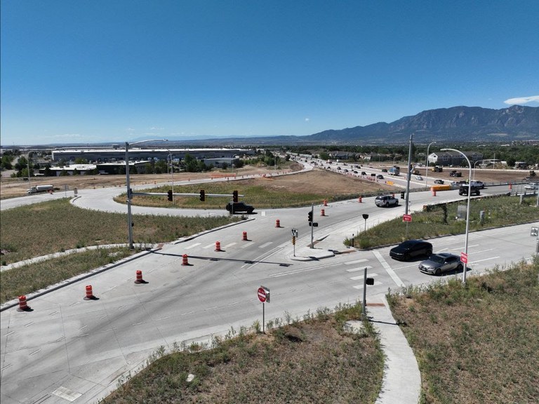 Motorists travel on the new Airport Road diverging diamond interchange over Powers Boulevard/CO 21.