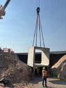Box culvert being lifted into place by crane with a crew member standing nearby thumbnail image