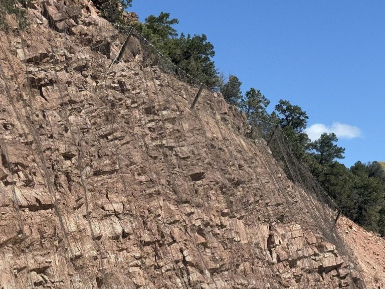 CO 82 rockfall mitigation includes post-mounted mesh netting to capture and direct falling rocks and debris safely and away from traffic.