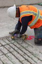 Bridge Repairs in Denver and Adams County Grinding rust off rebar inside Buckley Road bridge structure.jpg thumbnail image