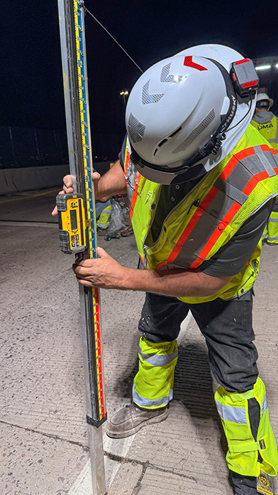 Bridge Repairs in Denver and Adams County I-25 and I-70 Construction worker monitor bridge elavation.jpg detail image