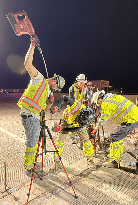 Bridge Repairs in Denver and Adams County I-25 and I-70 men drilling holes for injection rods.jpg detail image