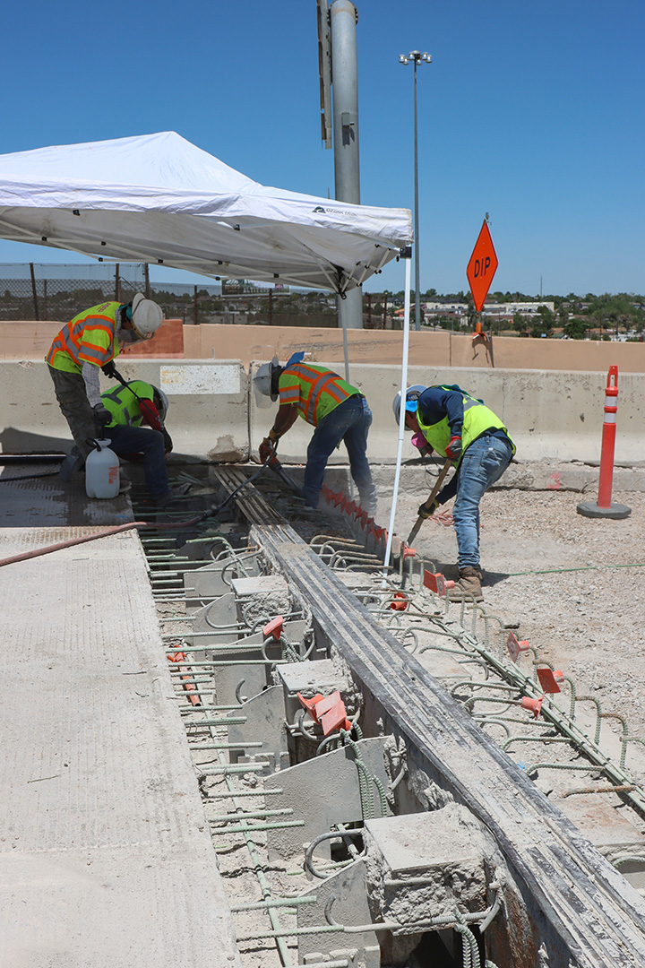 I-270 & US 36 Bridge Preventative Maintenance workers removing old concrete from bridge expansion joints under a shaded area.jpg detail image