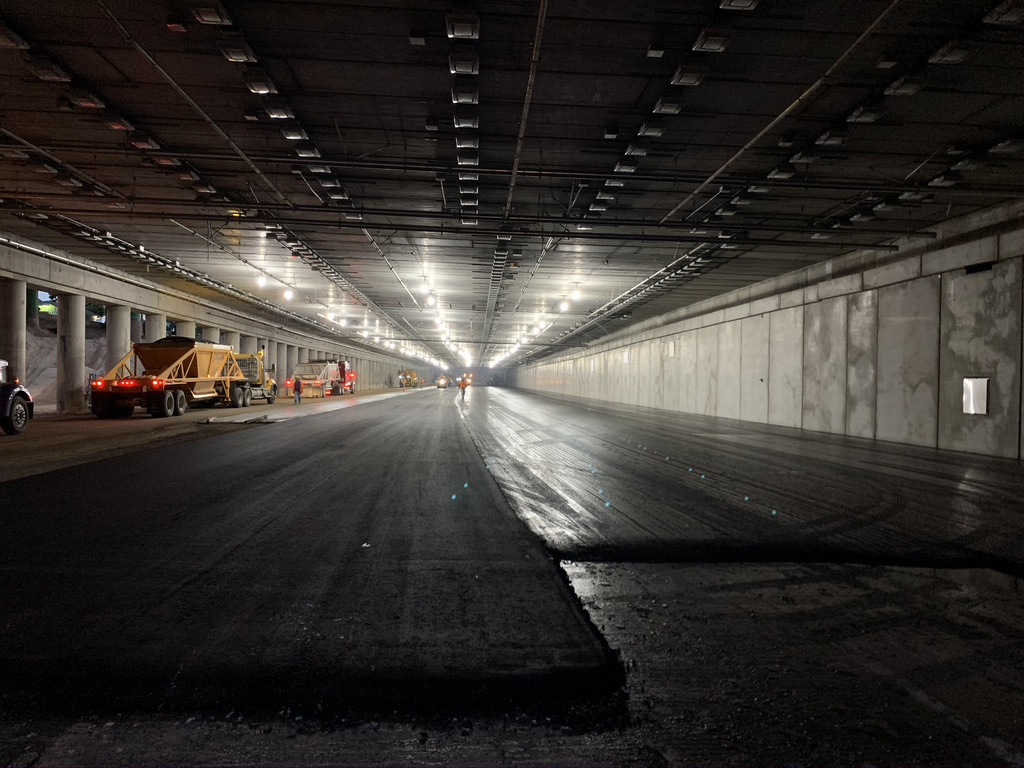 Paving operations for the future westbound I-70 lanes under the cover detail image