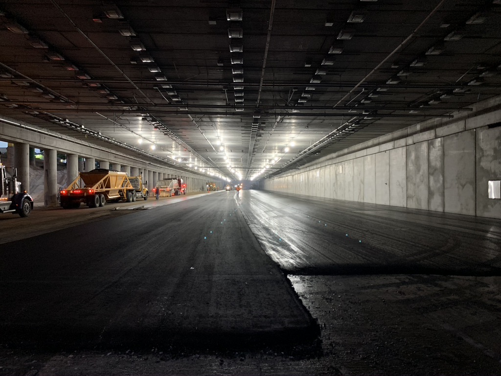 Paving operations for the future westbound I-70 lanes under the cover detail image