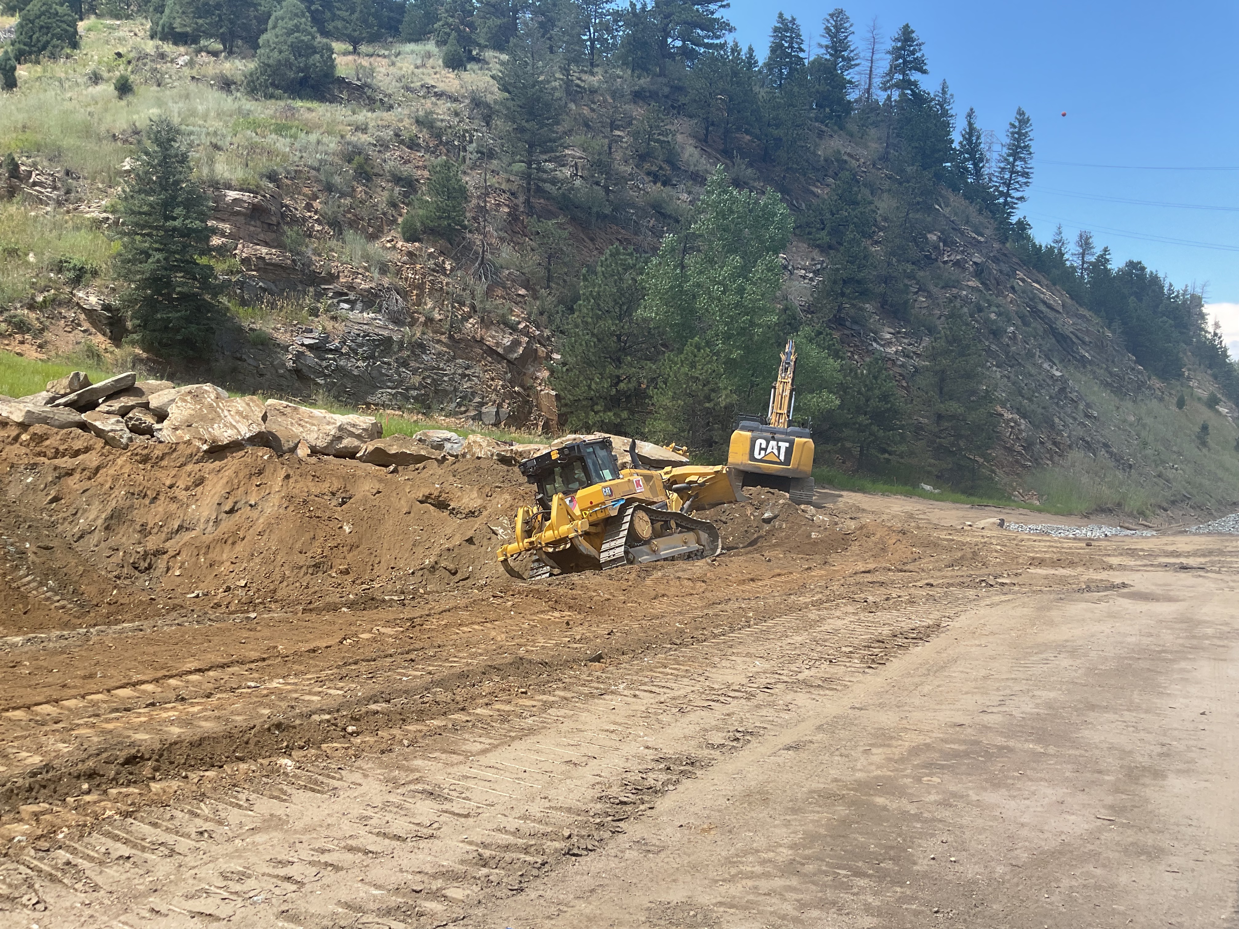 Pond grading with 40-ton haul truck and cat excavator | Alt text: Heavy machinery moving dirt. detail image