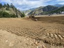 Construction equipment working on grading. | Alt text: Heavy machinery moving dirt. thumbnail image