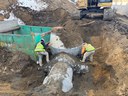 Two construction workers digging around drainage pipe. thumbnail image