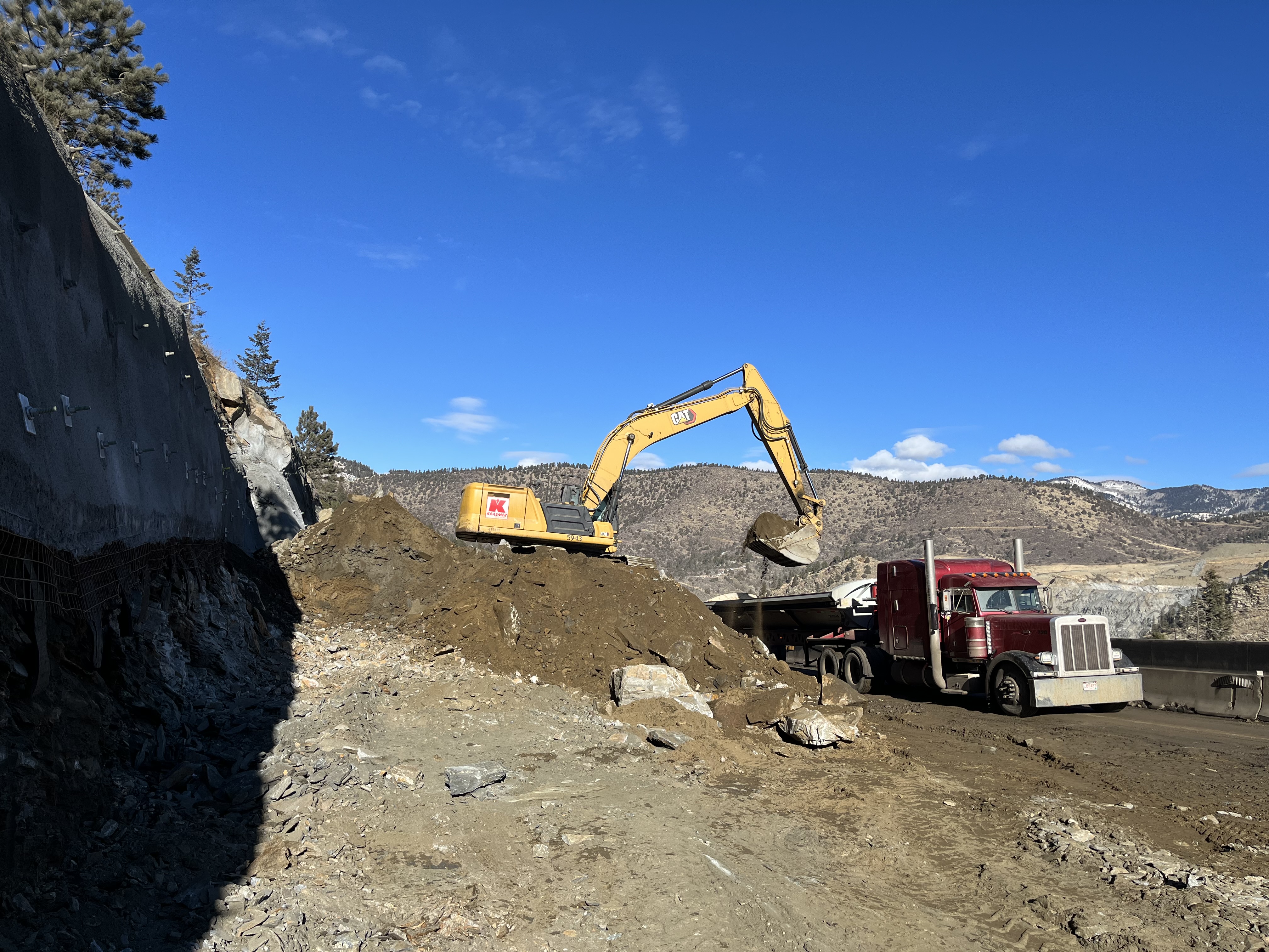 Excavator moving dirt detail image