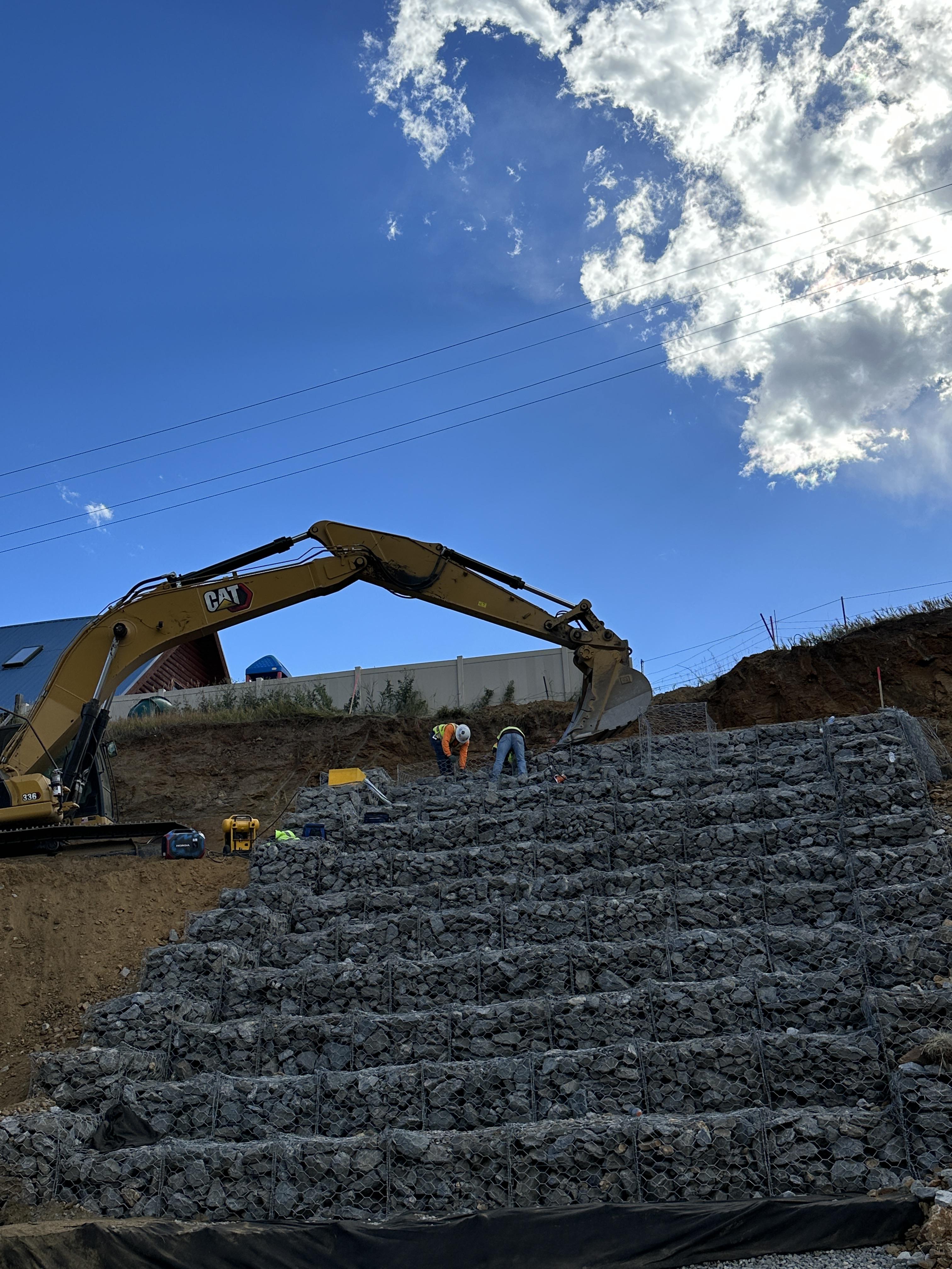 Rocks piled to look like stairs along a hillside that helps with drainage. detail image