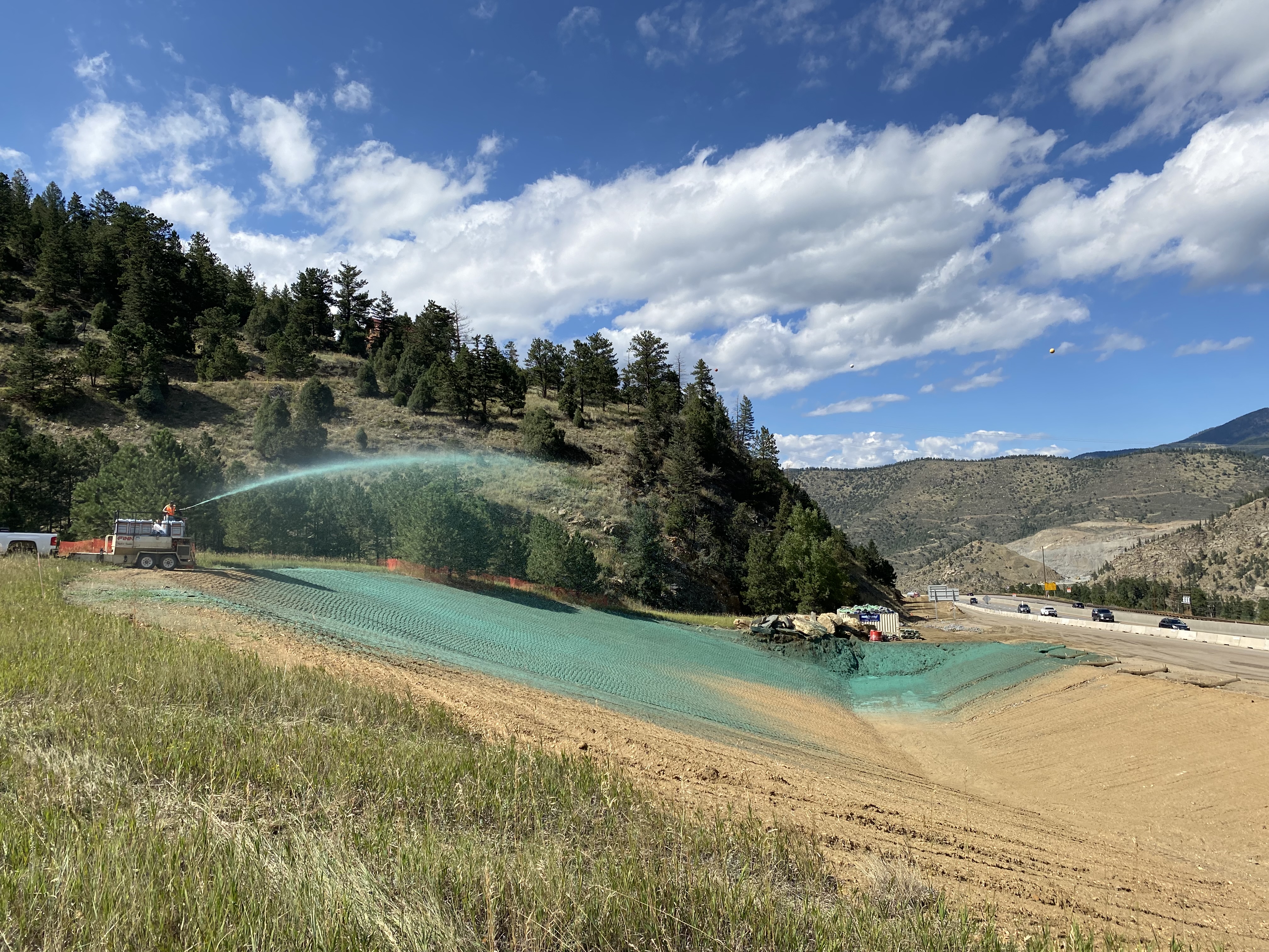 Heavy equipment completing seeding operations for soil stabilization. detail image