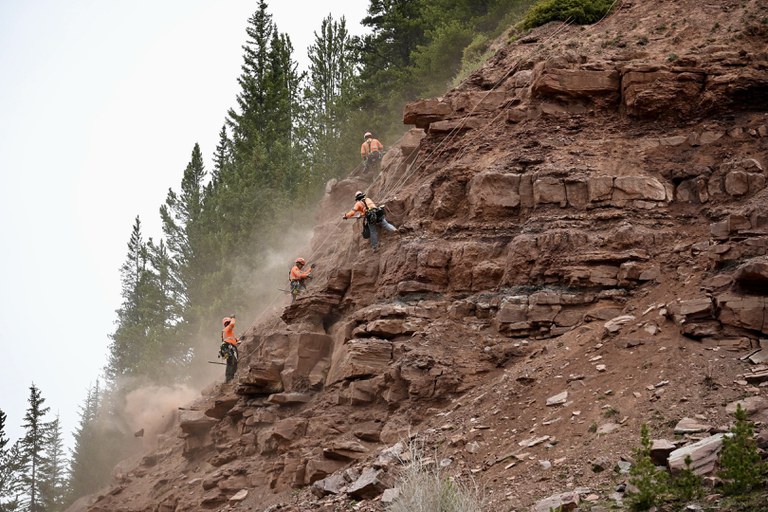 Specialty crews rappelling along I-70 in “The Narrows,” in June 2025, to perform rock scaling as part of the new avalanche and rockfall mitigation system.