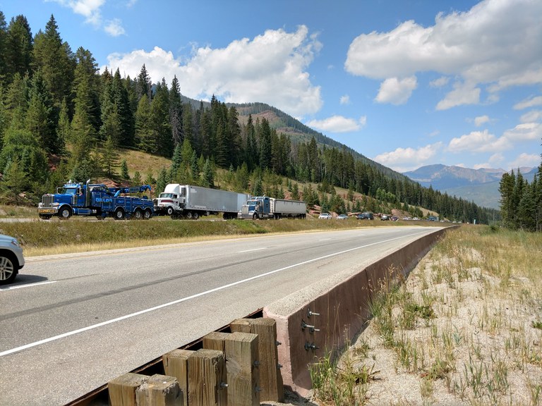 Photo of trucks and vehicles backed up on highway with clear line in front