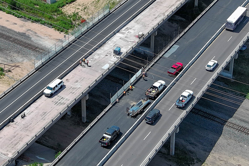 Crews are installing railroad fencing on the South Academy Boulevard bridge to prevent debris from falling onto the tracks below.jpg detail image