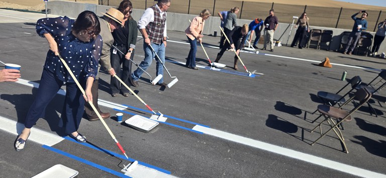 CDOT, FHWA, and local partners painted lane stripes on the highway to celebrate a major milestone for the I-25 North Express Lanes project