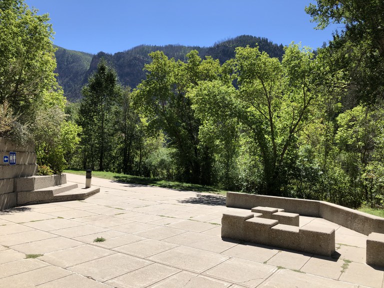 The front area of the Grizzly Creek rest area overlooking the mountains and concrete blocks for seating
