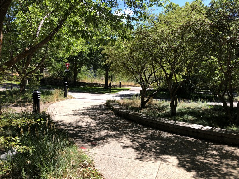 A paved trail from the parking lot to the rest area building