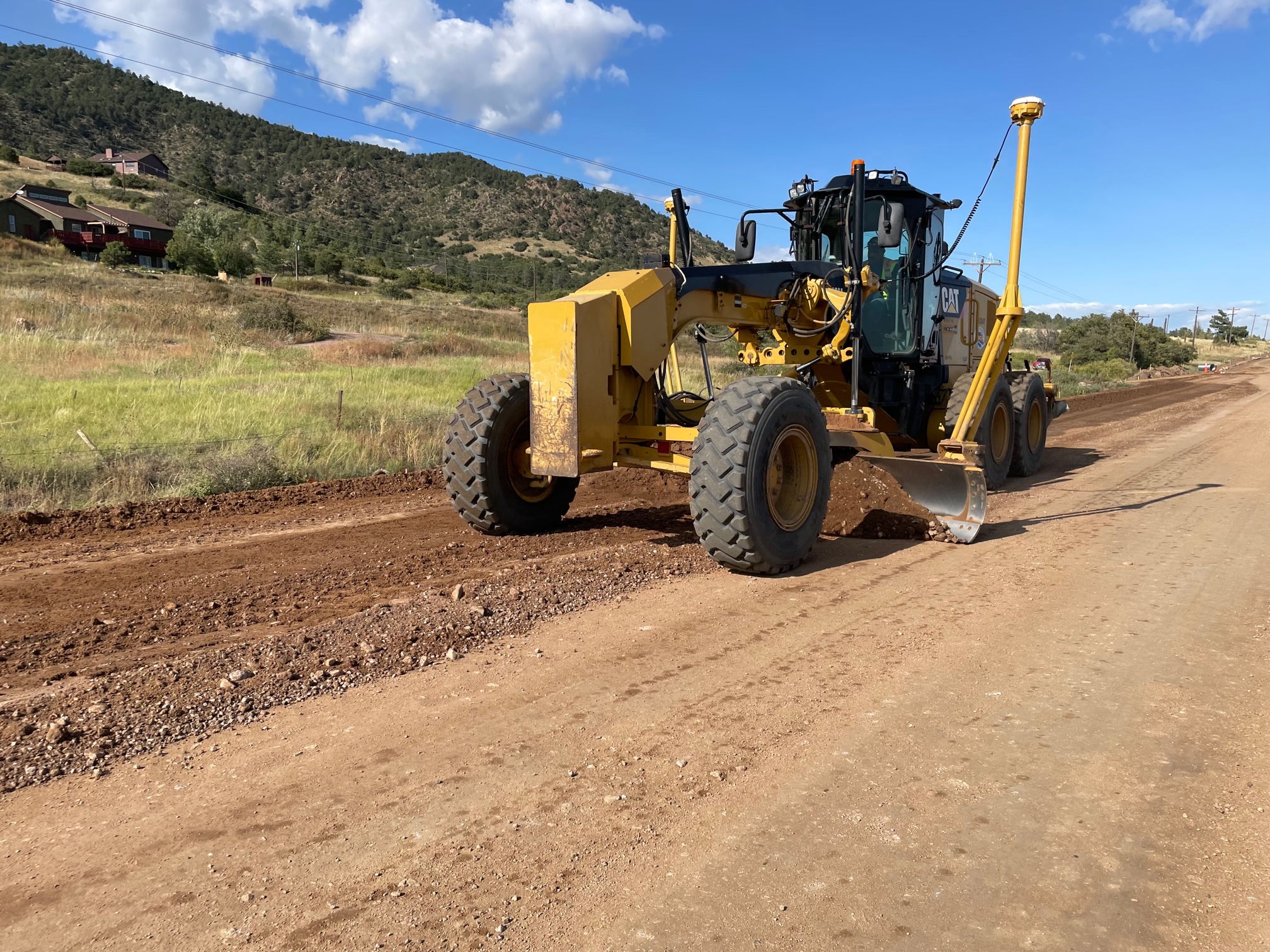 tractor preparing roadway for new concrete paving