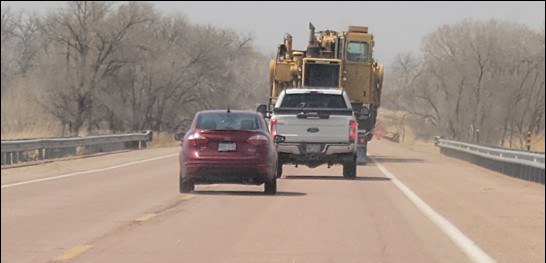 Oversized load on US 50B prohibits traffic from passing easily and safely