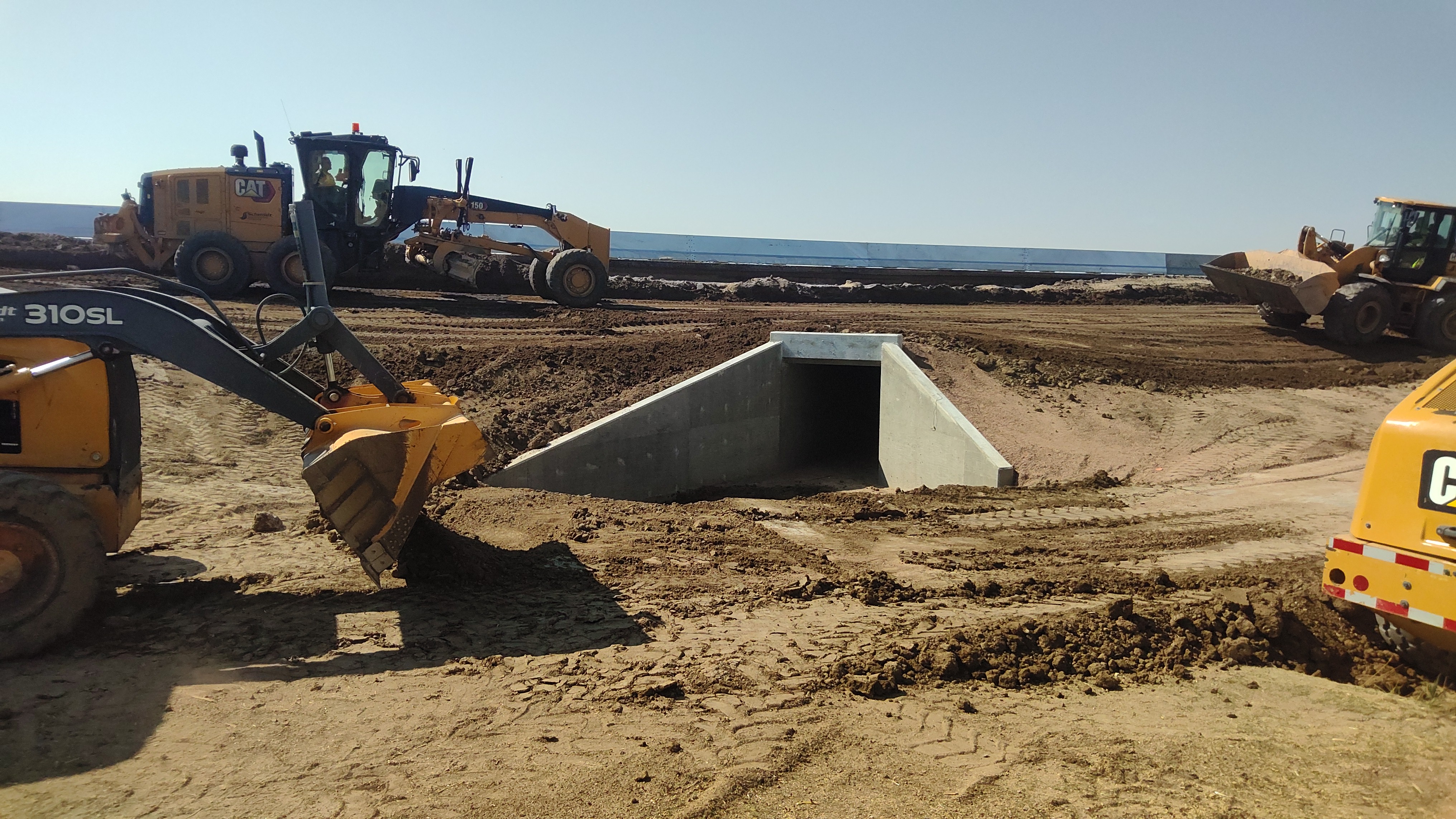US 24 Resurfacing from Peyton to Calhan - Heavy equipment backfilling the box culvert extension and grading.jpg detail image