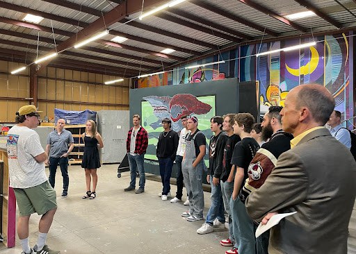 A group of students and families gather at the Lumenati Productions warehouse for the distracted driving video contest celebration event. 