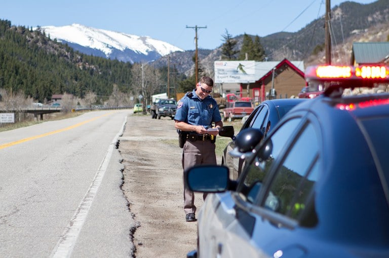 Colorado State Patrol Roadside Stop Police officer gathering information during a roadside stop