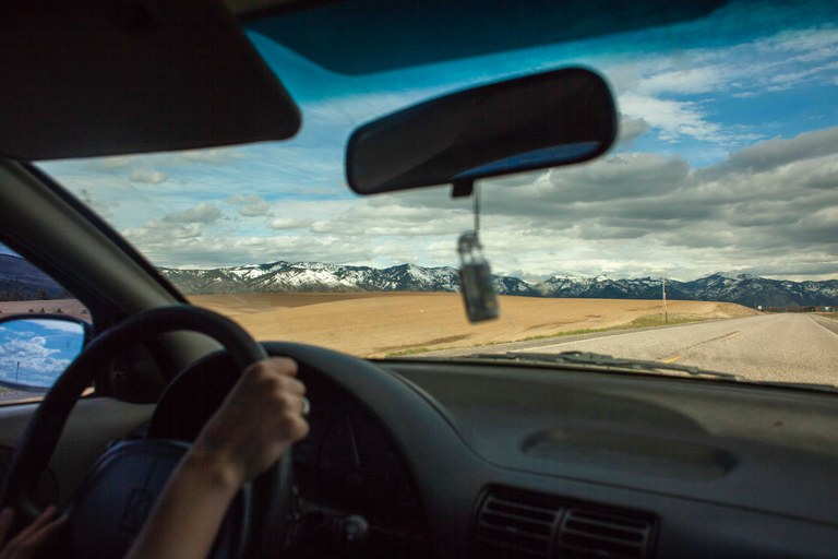 View from inside car, looking out towards mountainous landscape