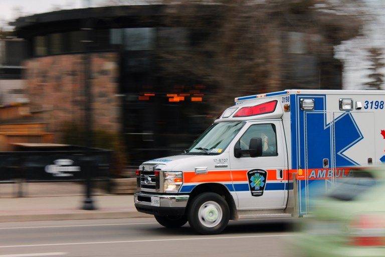 Ambulance racing through a city intersection  