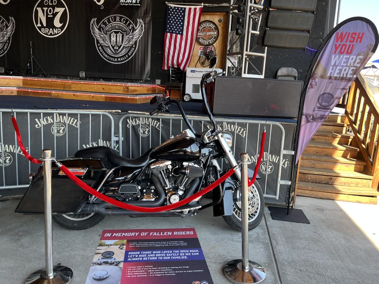 Motorcycle on display next to a banner that says "Wish you were here."