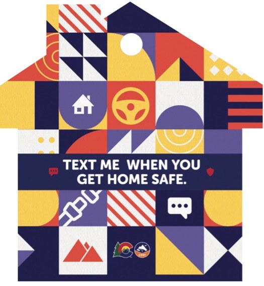 Multicolored house-shaped car freshener with text overlay reading “Text me when you get home safe.”