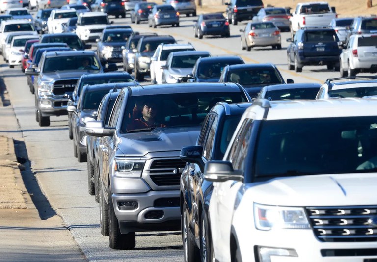 Heavy traffic on a wide city street.