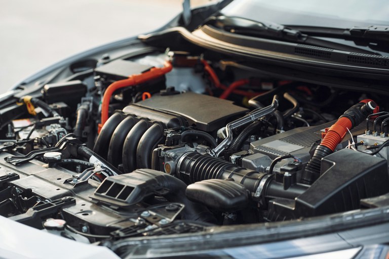 Photo of a car with the hood open, displaying its engine