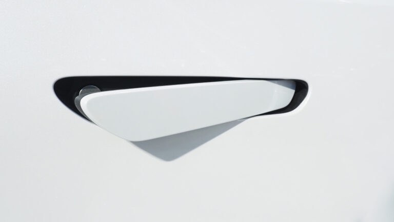 A handle of an electric vehicle sticking out of its hold.
