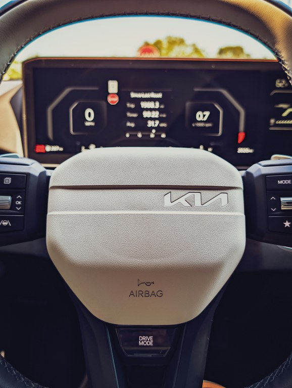 IIHS pushes improvements in crash avoidance with 2026 awards Interior view of a Kia SUV with the steering wheel and digital instrument cluster.