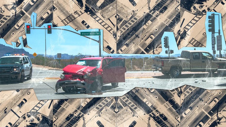 Car crash at an intersection with a red SUV, tan truck and black police vehicle.