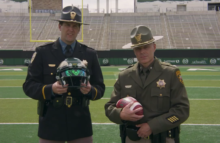 State troopers holding a CSU Rams helmet and football 