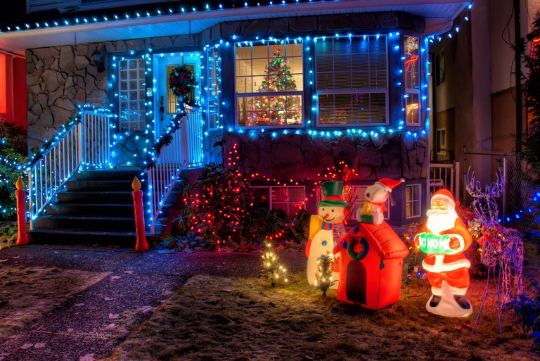 A home at night time decorated in holiday lights and figures