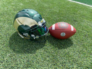 Colorado State Rams football helmet and football sit side by side