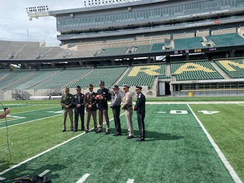 Group of Law Enforcement Liaisons on the Colorado State Football field