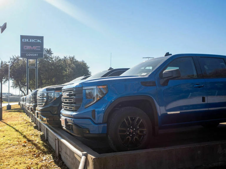 GMC pickup trucks on a lot at a General Motors dealership in Austin, Texas. The average U.S. passenger vehicle has gotten about 8 inches taller in the last 30 years, according to the Insurance Institute for Highway Safety.