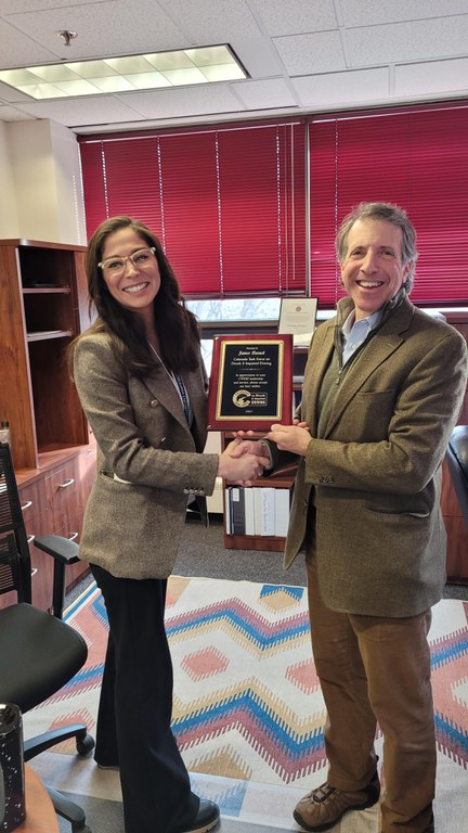 Dominique Mendiola from the Marijuana Enforcement Division (MED) presented a plaque of appreciation to Jim Burack for his service to the CTFDID while representing the MED. 