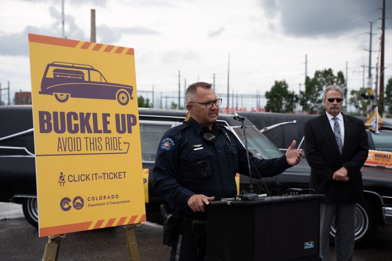 Paul Timmons, Aurora PD, speaking at the Click It or Ticket seat belt hearse parade on June 16