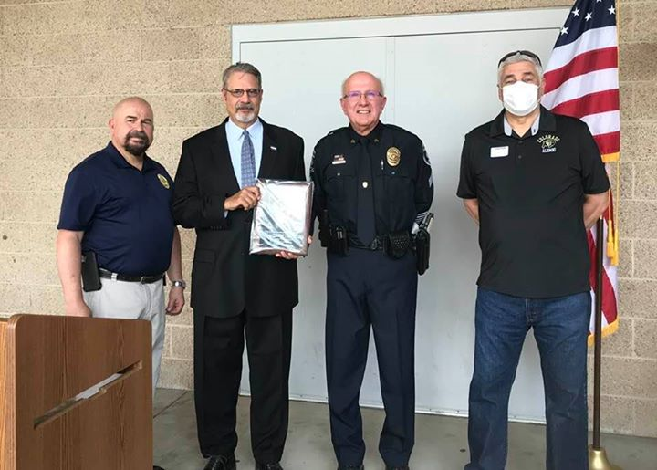 Glenn Davis with CDOT presents the recognition award. Chief Rick Bashor on the far left, Retired DRE Mark George on the right.