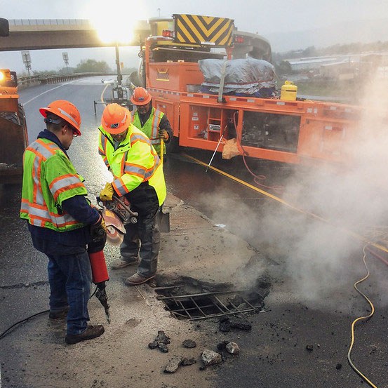 crews repairing a hole on a bridge